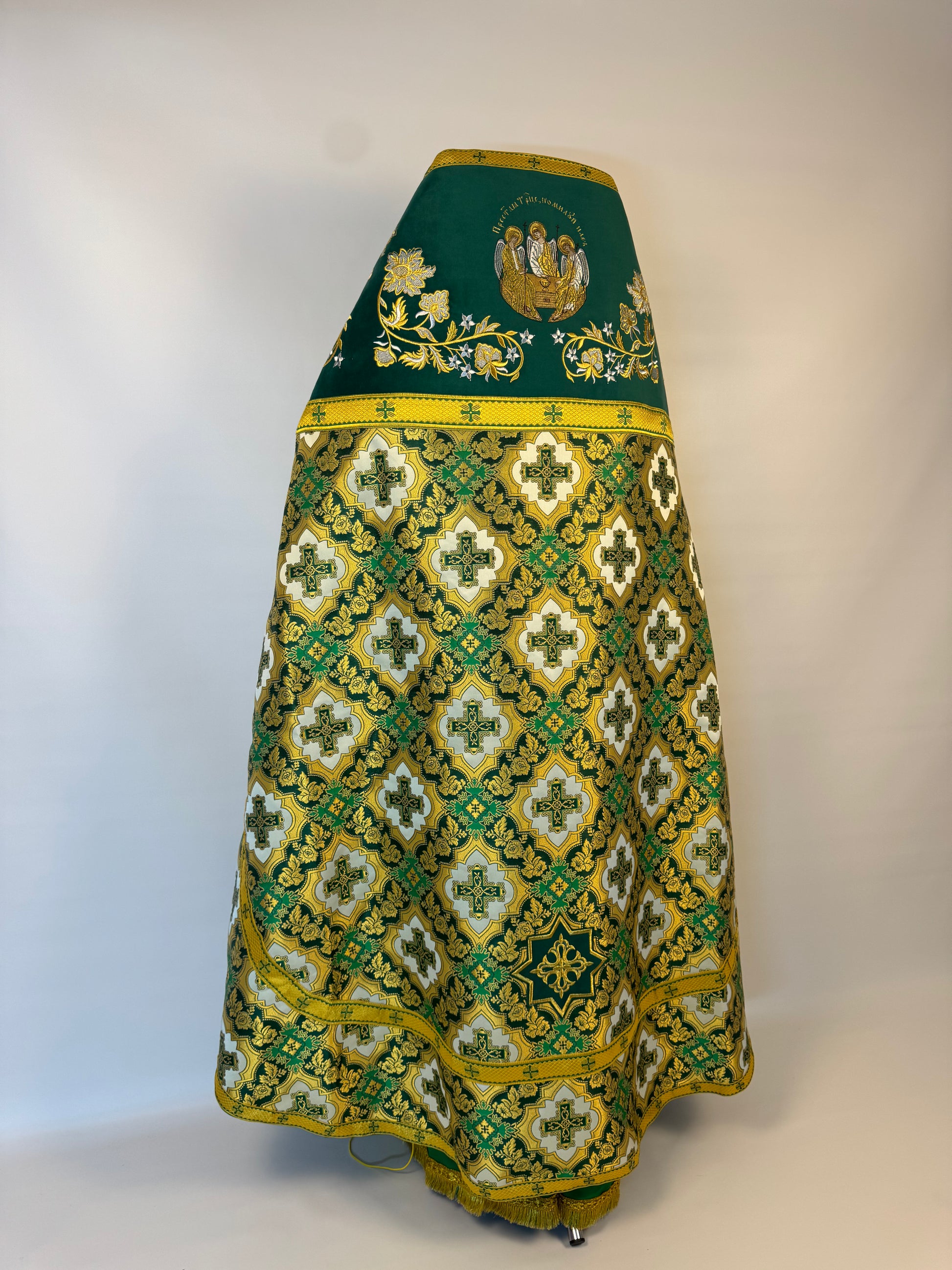 Green and gold patterned skirt on a white background