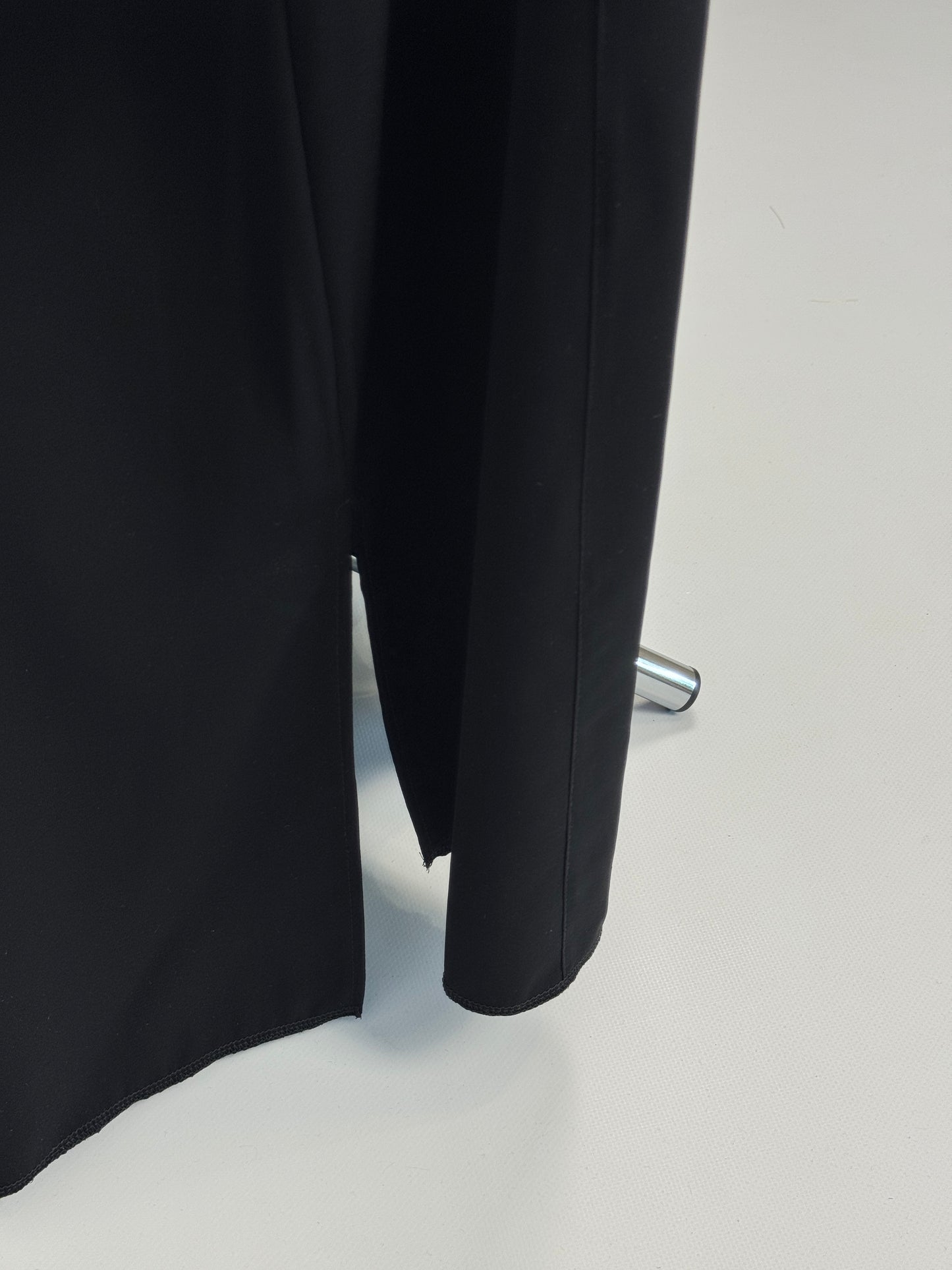 Black outer cassock with burgundy lining on the sleeves
